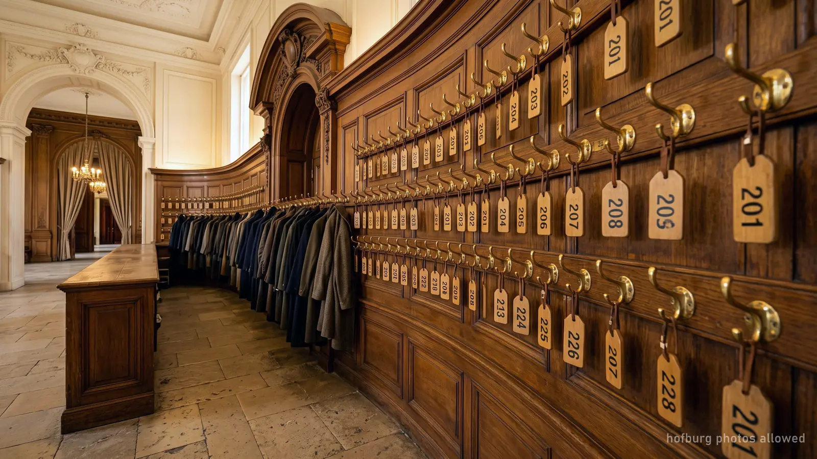 A palace museum cloakroom with brass hooks and numbered wooden tags