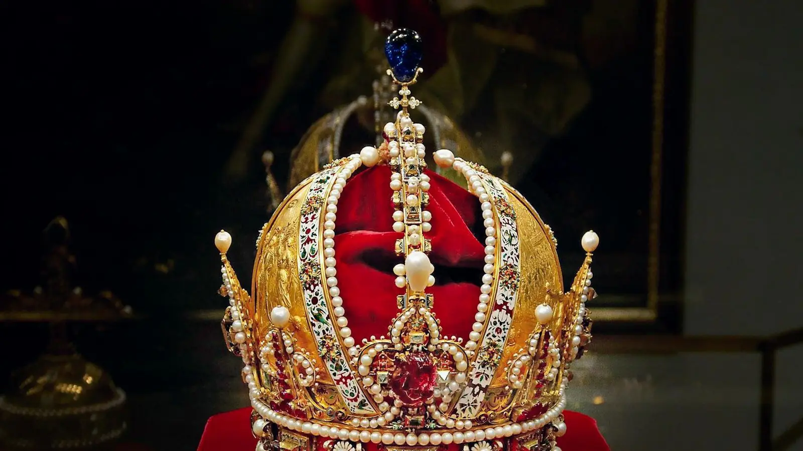 A crown displayed under spotlights in the Imperial Treasury, Vienna — photo from the booking listing